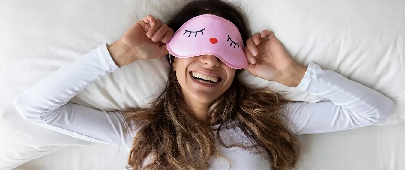 smiling woman with a sleeping mask