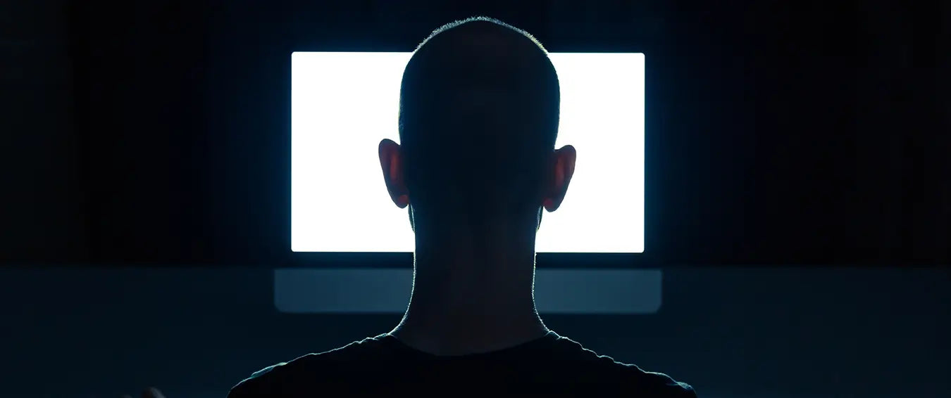 man in front of the screen in a dark room