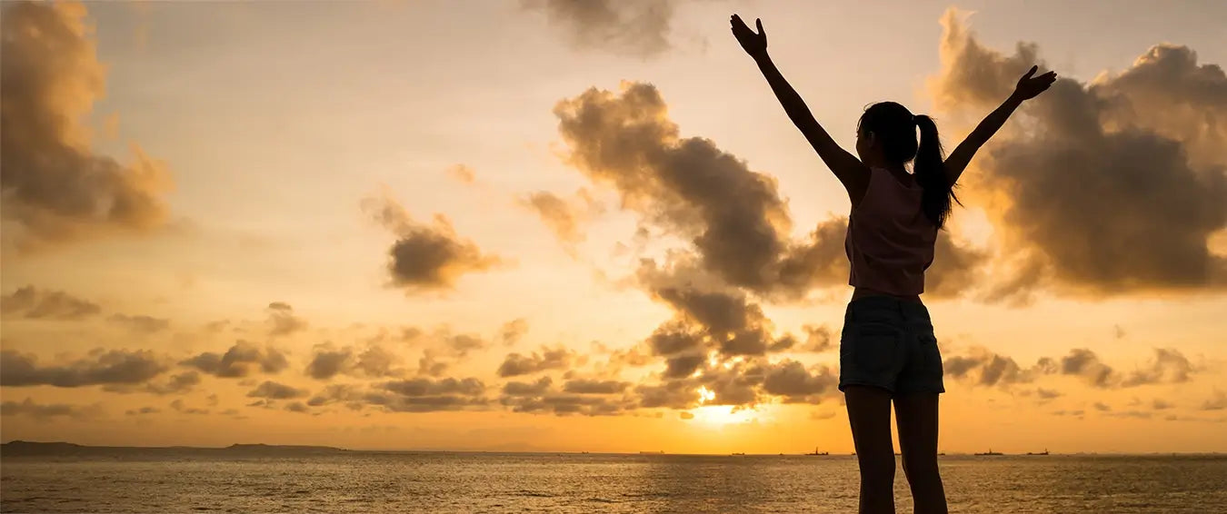 grateful woman at sunset