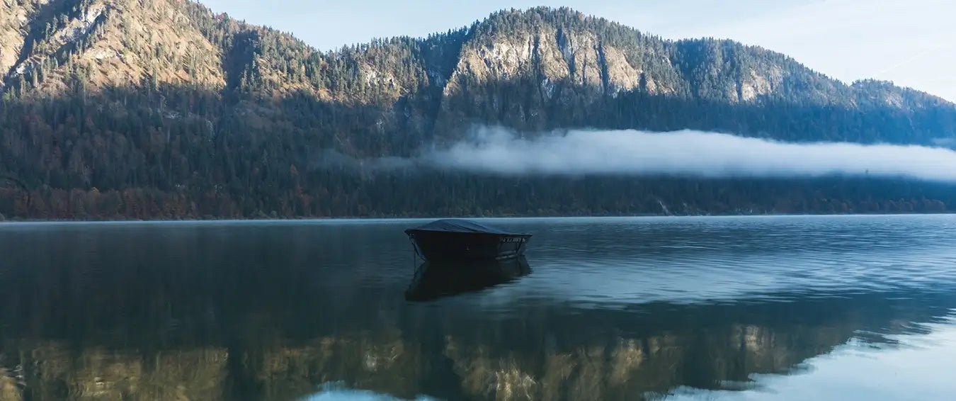 calm lake with a small boat in the middle