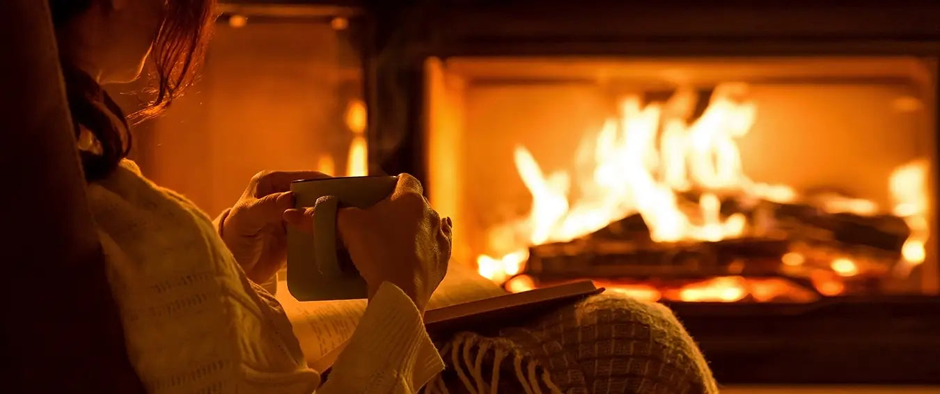 relaxing by the fire with a cup of tea and a book