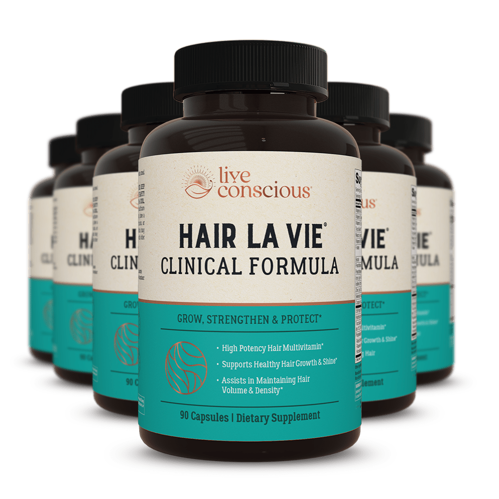 Hair La Vie Clinical Formula dietary supplement bottles with black caps and turquoise labels, 90 capsules per bottle